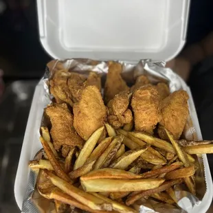 Fried chicken wings and fresh cut potato fries