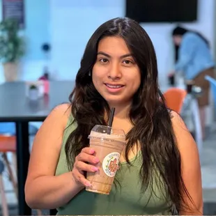 a woman holding a cup of coffee