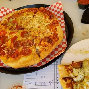 Half cheese, half pepperoni pizza and pesto cheese sticks.