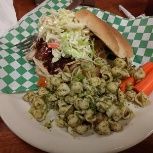 Pulled chicken sandwich with pesto pasta.