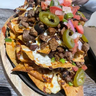 Tri tip nachos. 8/10 . Delicious, stacked super high which made it messy AF but good