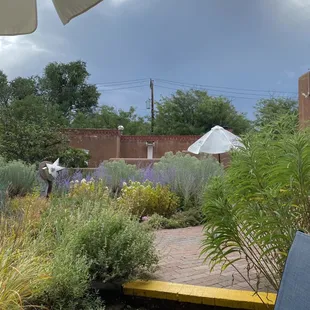 a patio with chairs and an umbrella