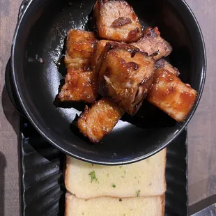 Pork belly burnt ends with toast.