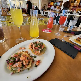 a plate of appetizers and a glass of orange juice