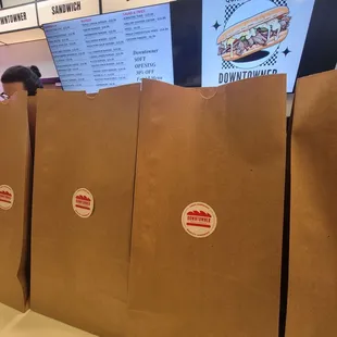 Their bags with the logo and menu behind