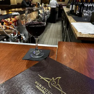 a glass of wine and menu