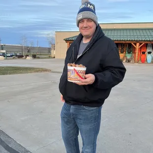 a man holding a donut