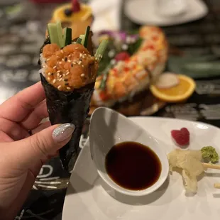 a person holding a sushi