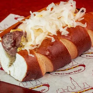 a hot dog with sauerkraut and onions