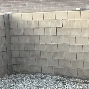 Backyard wall cracked on the bottom and separating on it's way to collapse