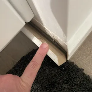 a hand pointing at a door