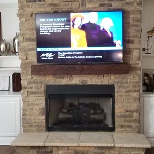 TV Mounted over mantel with all equipment hidden in cabinets.