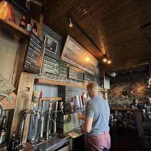 a man filling a beer at a bar