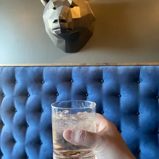 a hand holding a glass of water