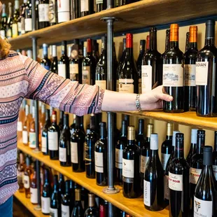 a woman selecting wine