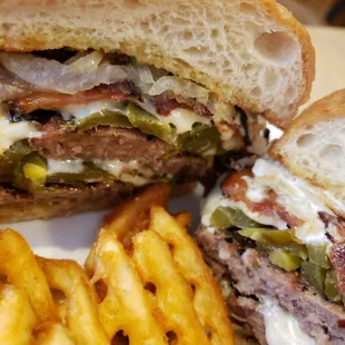 &quot;The Prospector&quot; Juicy half pound burger served on a French roll with grilled onions, jalapeno peppers, gooey cheese, bacon and ranch