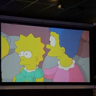 Big, big screen in back for game watches