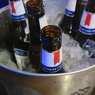 a bucket full of beer bottles