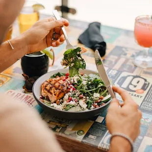 a man eating a salad at a restaurant