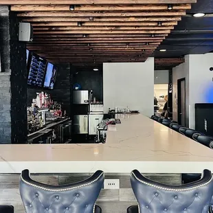 TV and bar area with chef station behind.