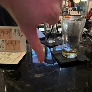 a person&apos;s hand reaching for a drink