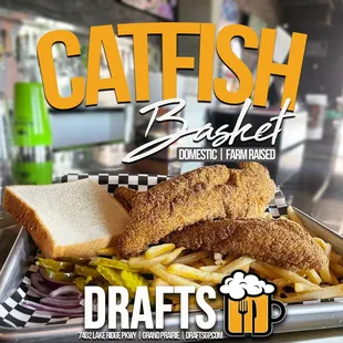 a tray of fish and fries with a beer