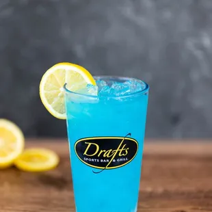 a blue drink with lemon wedges