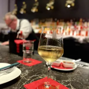 Charles at the bar pouring wine.
