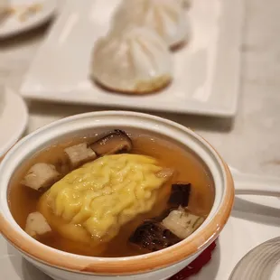 a bowl of soup and dumplings