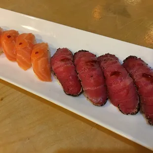 a variety of sushi on a white plate