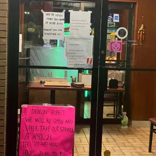 a pink sign in front of a restaurant