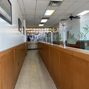 a long hallway with a sign on the floor