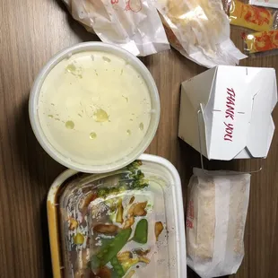 Delivery packaging of Four Seasons, egg drop soup, egg rolls and rice.