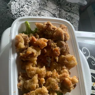 a tray of fried chicken and broccoli