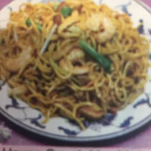 a plate of noodles and shrimp