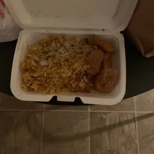 a person standing in front of a container of food