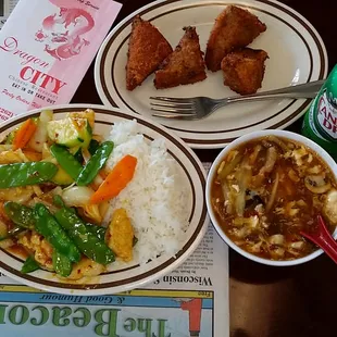 a plate of food and a can of soda