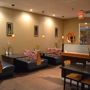 a dining area with tables and chairs