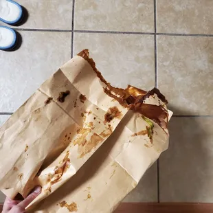 a person holding a bag of food