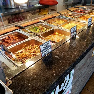 a variety of food in a buffet