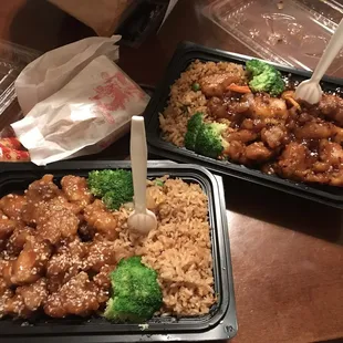 two takeout containers of chinese food