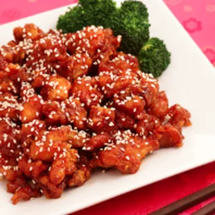 a plate of chinese food with broccoli