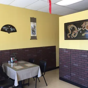 a dining area with a table and chairs
