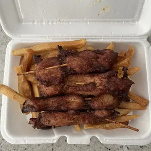 Chicken on a stick with fries
