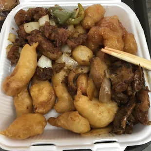 a takeout container of chinese food
