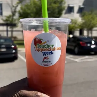 a hand holding a drink