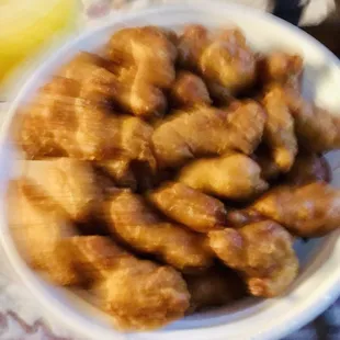 a bowl of chicken nuggies and a glass of orange juice