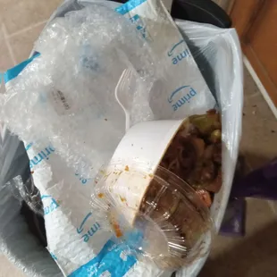 a bag of food in a trash can