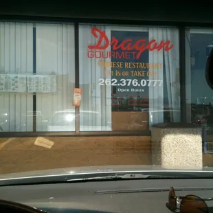 a view of a restaurant through a car window