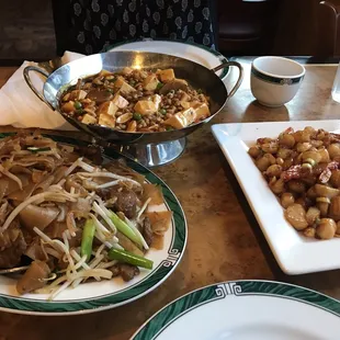 ma po tofu on top, beef chow fun to the left, kung pao scallops on the right